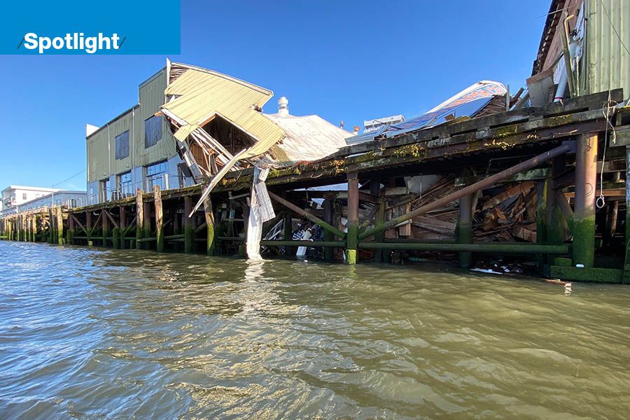 This photo shows the collapsed walls of the Buoy Brewery on a dock on the Columbia River in Astoria, Oregon.